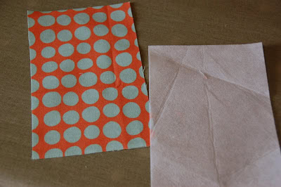 red, blue and coral fabric during construction process with sewing notions