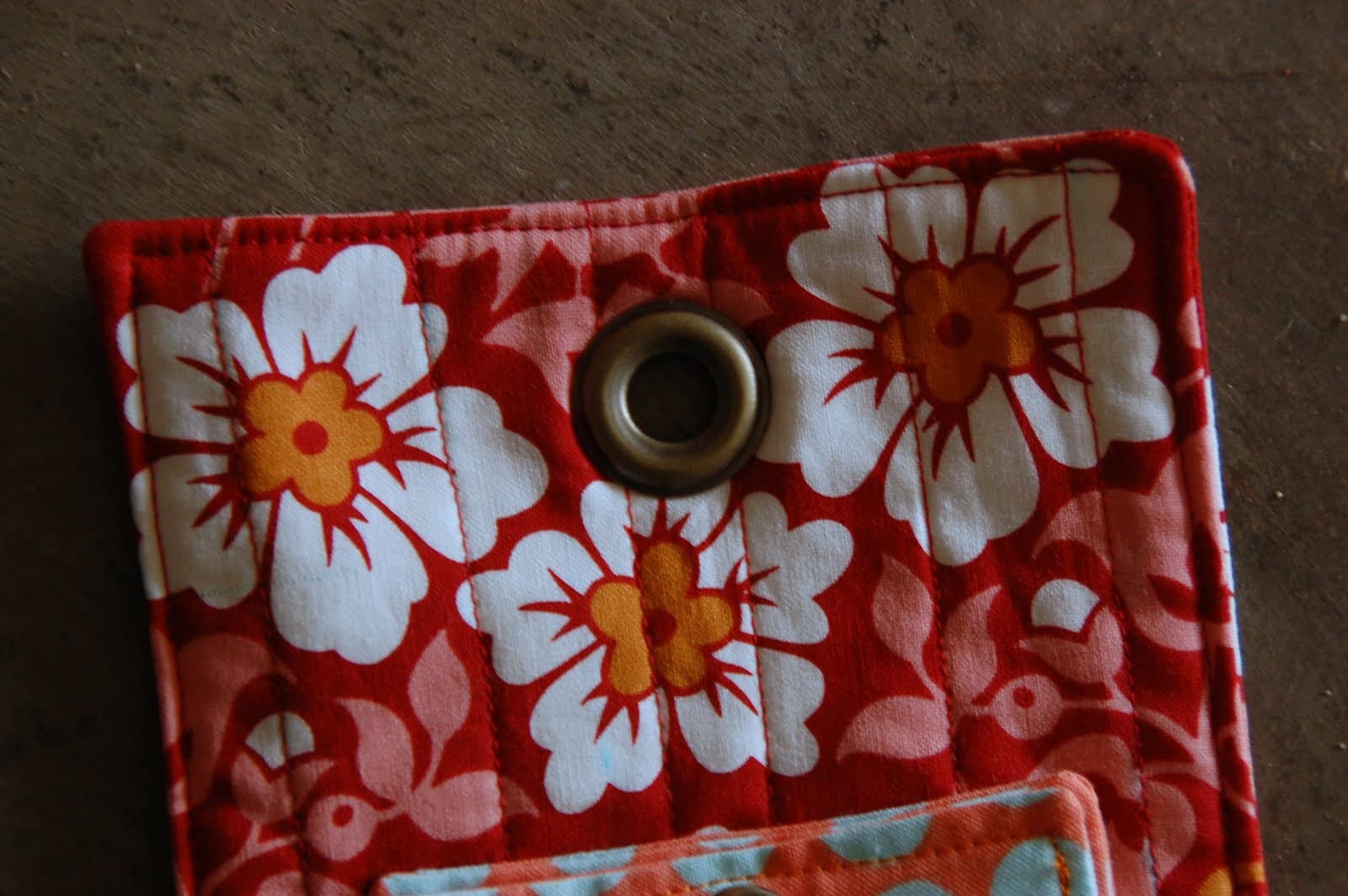 red, blue and coral fabric during construction process with sewing notions