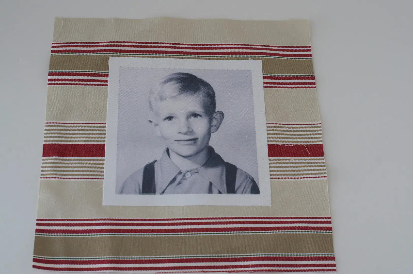 vintage photo on fabric that is striped beige, white and red