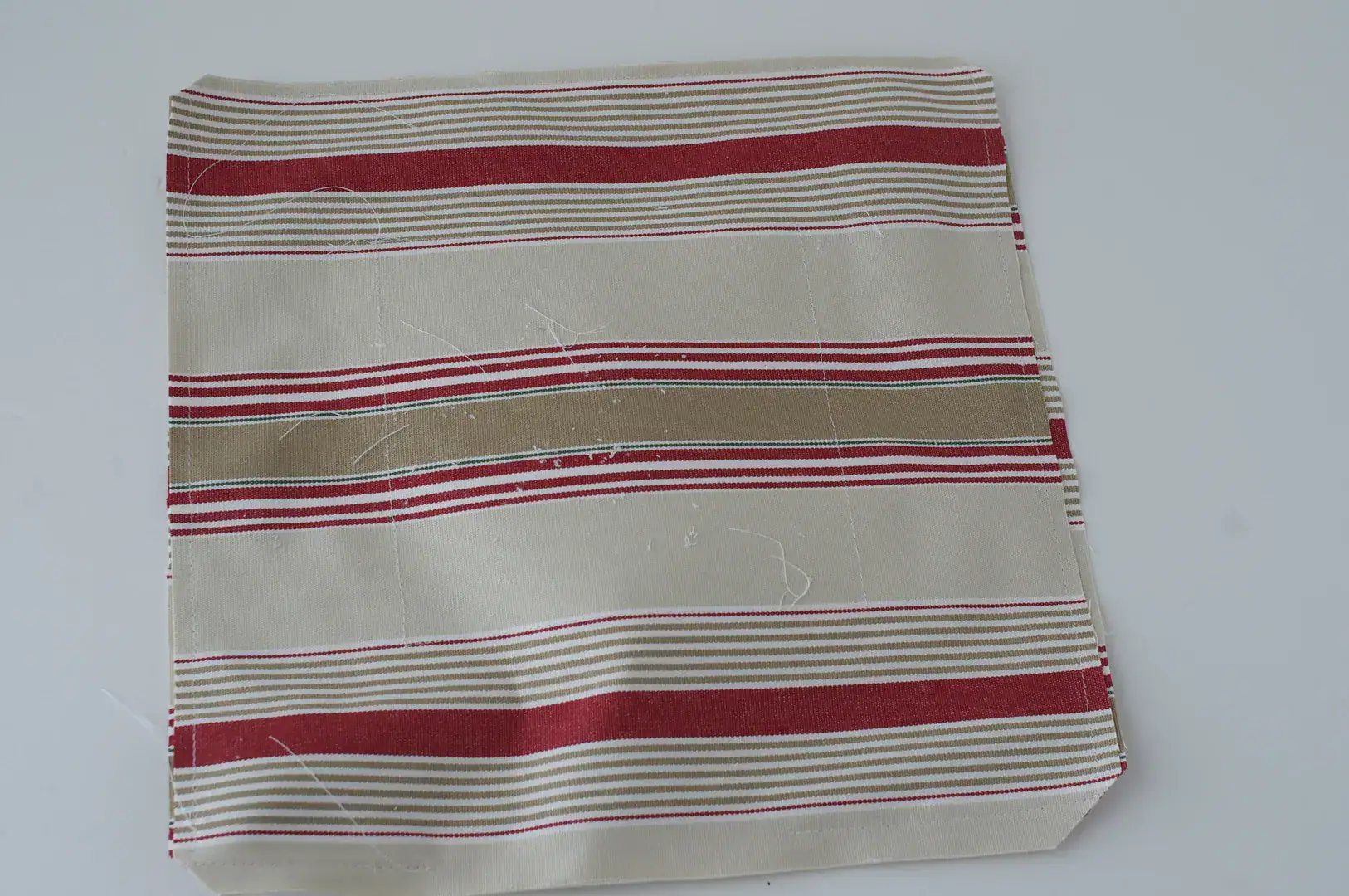 beige white and red fabric on white table