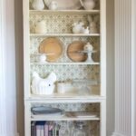 DIY Stenciled Bookcase Project, she painted the bookcase with chalk paint then stenciled a pattern onto the back, looks pretty simple