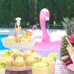 Lots of fun ideas to throw a backyard flamingo themed pool party, including free printable silverware containers and a recipe for pineapple and mango virgin pina coladas