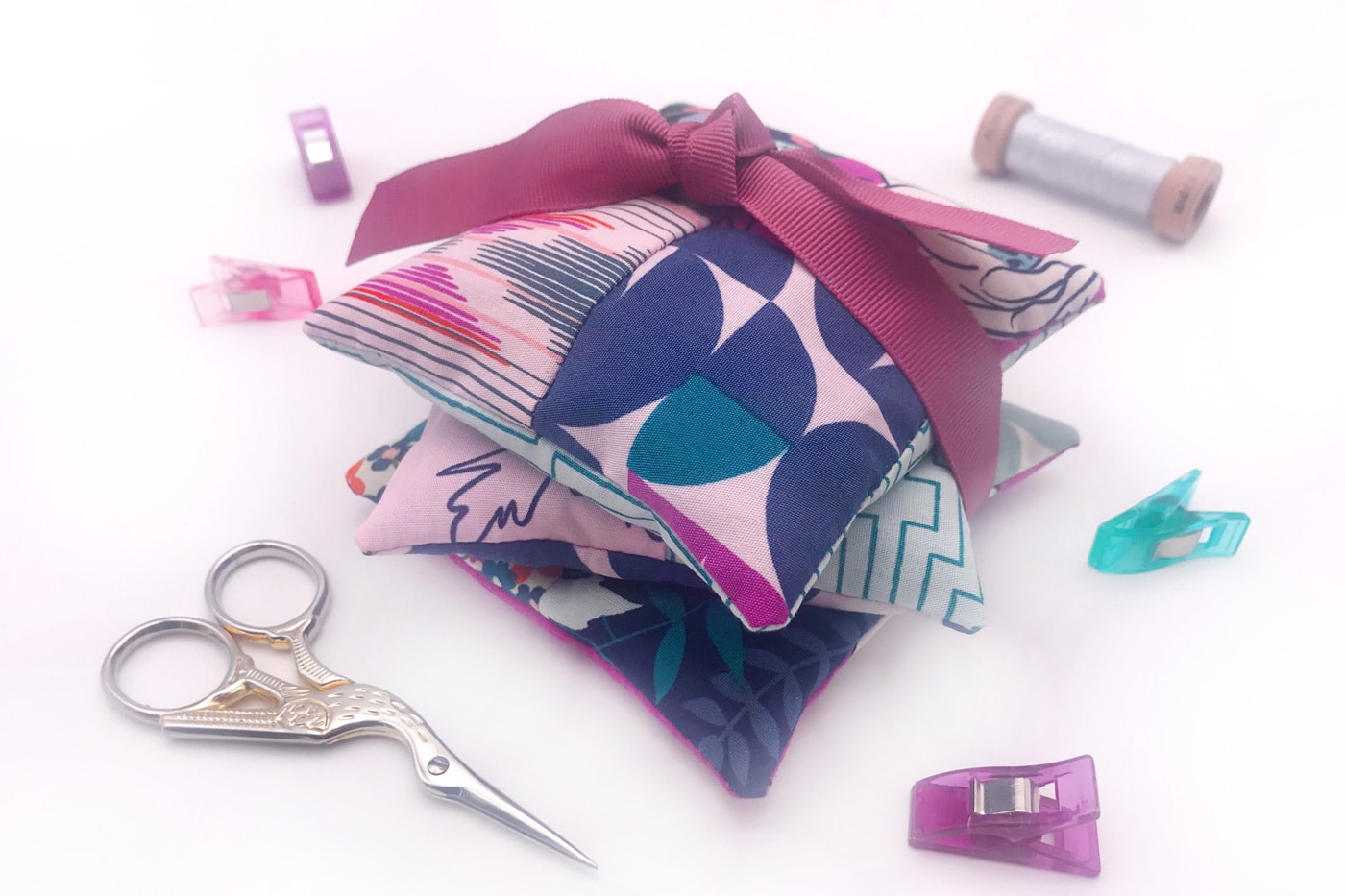 stack of lavender sachets tied up with ribbon on white table