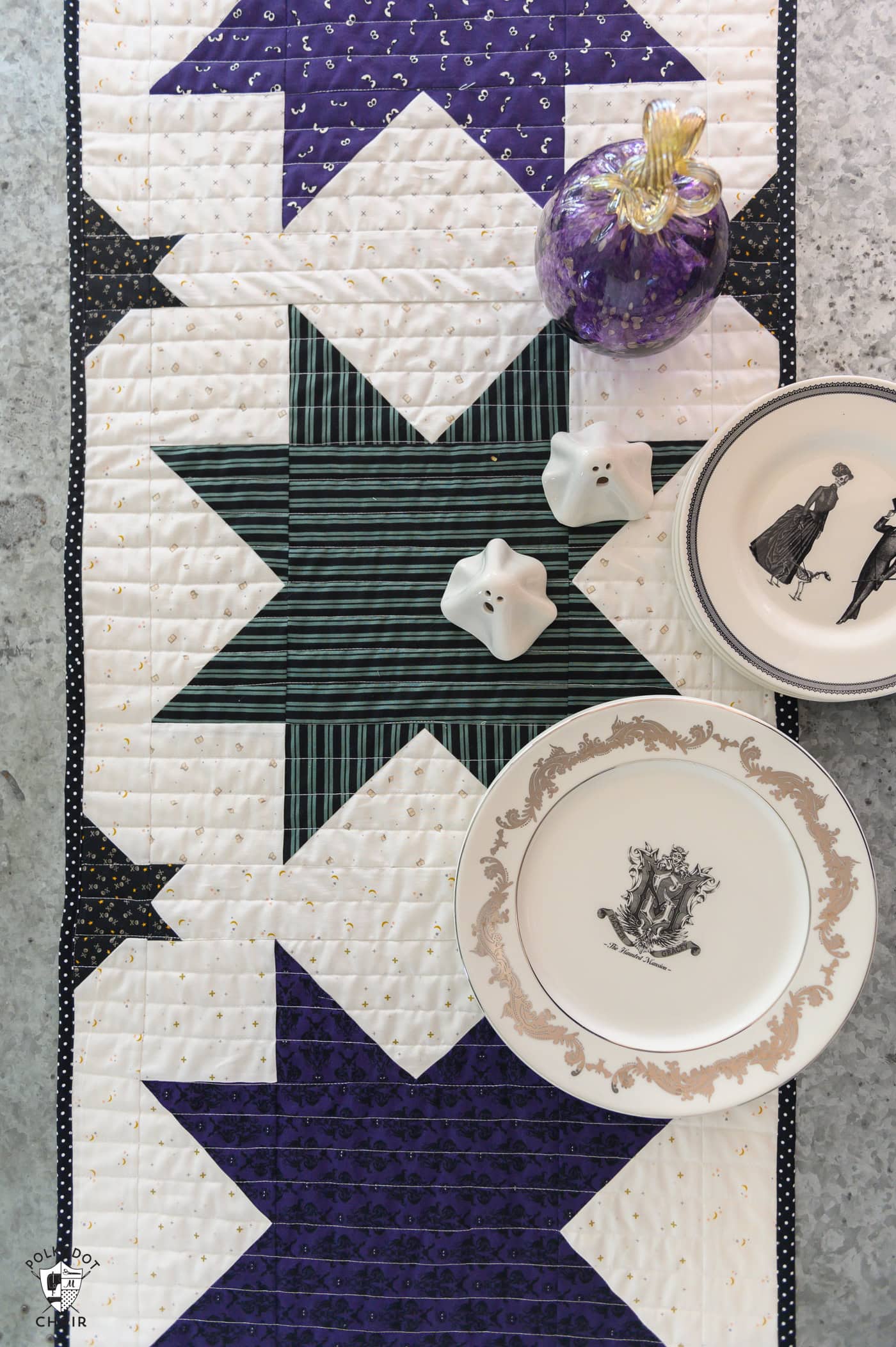 close up of table runner on metal table with plates