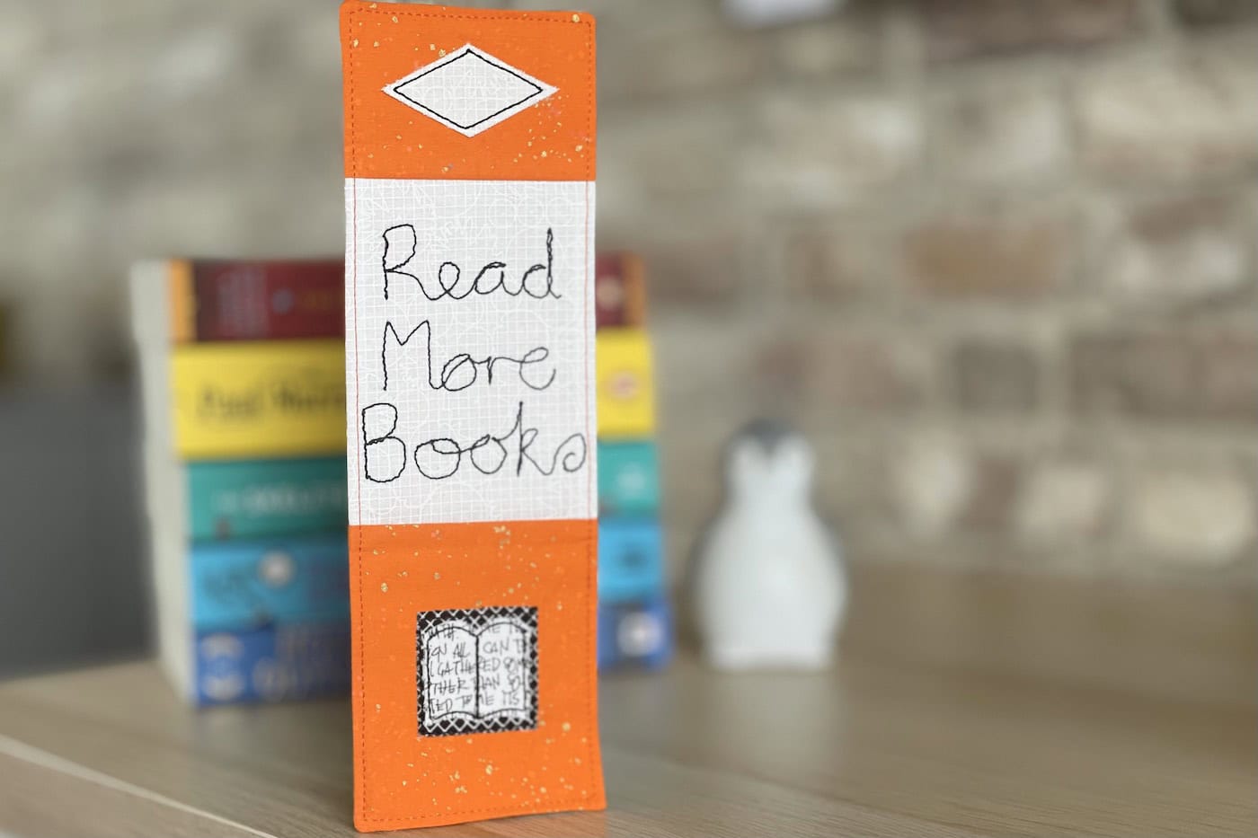 orange bookmark on book on wood table with other books