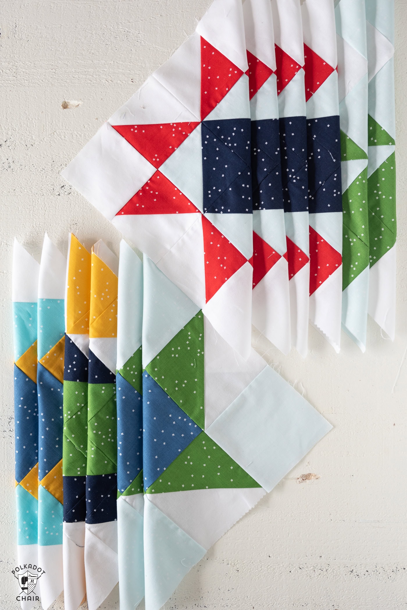 stack of folded quilt blocks on white table