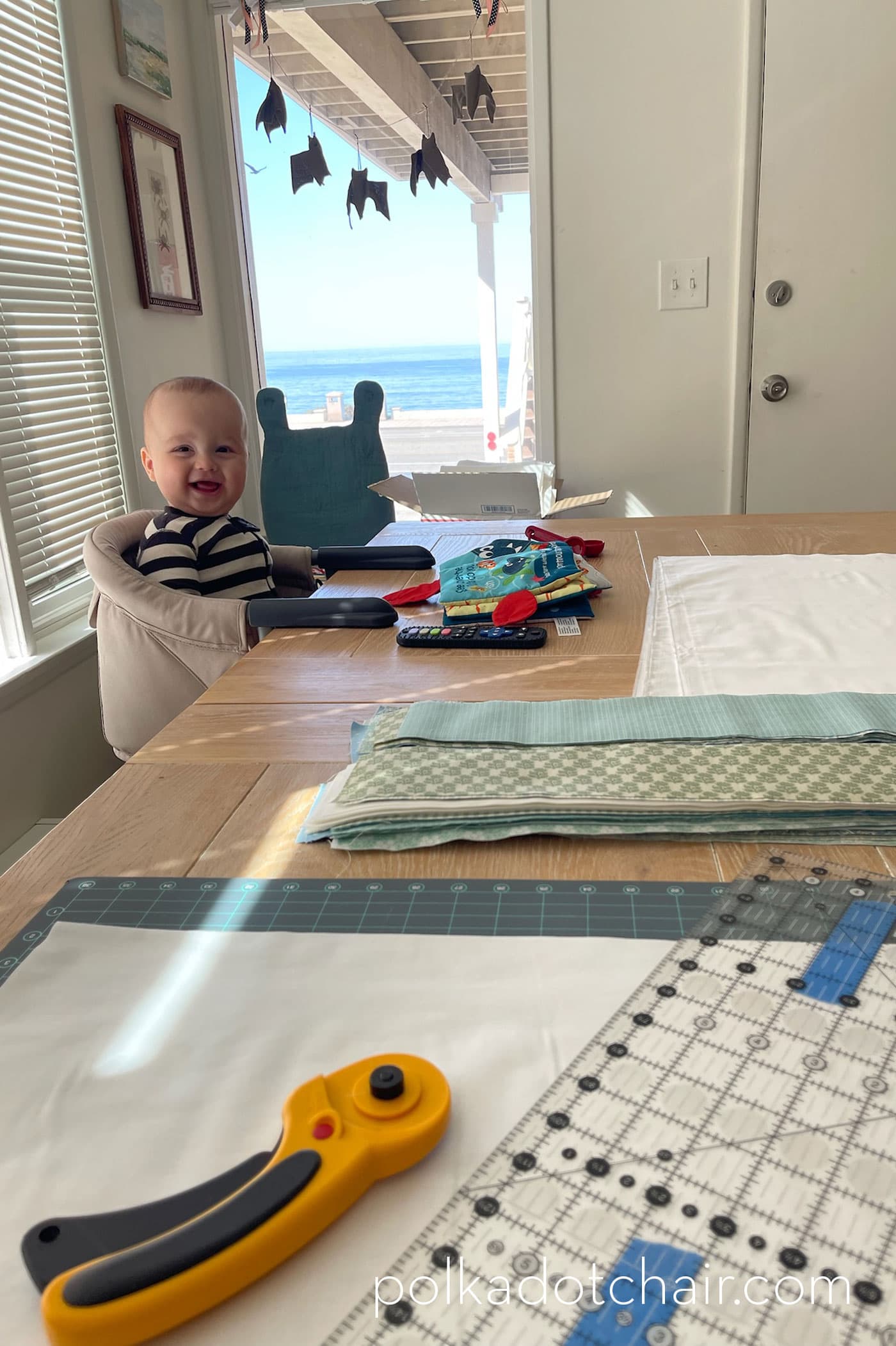 woman taking selfie with quilt supplies in background