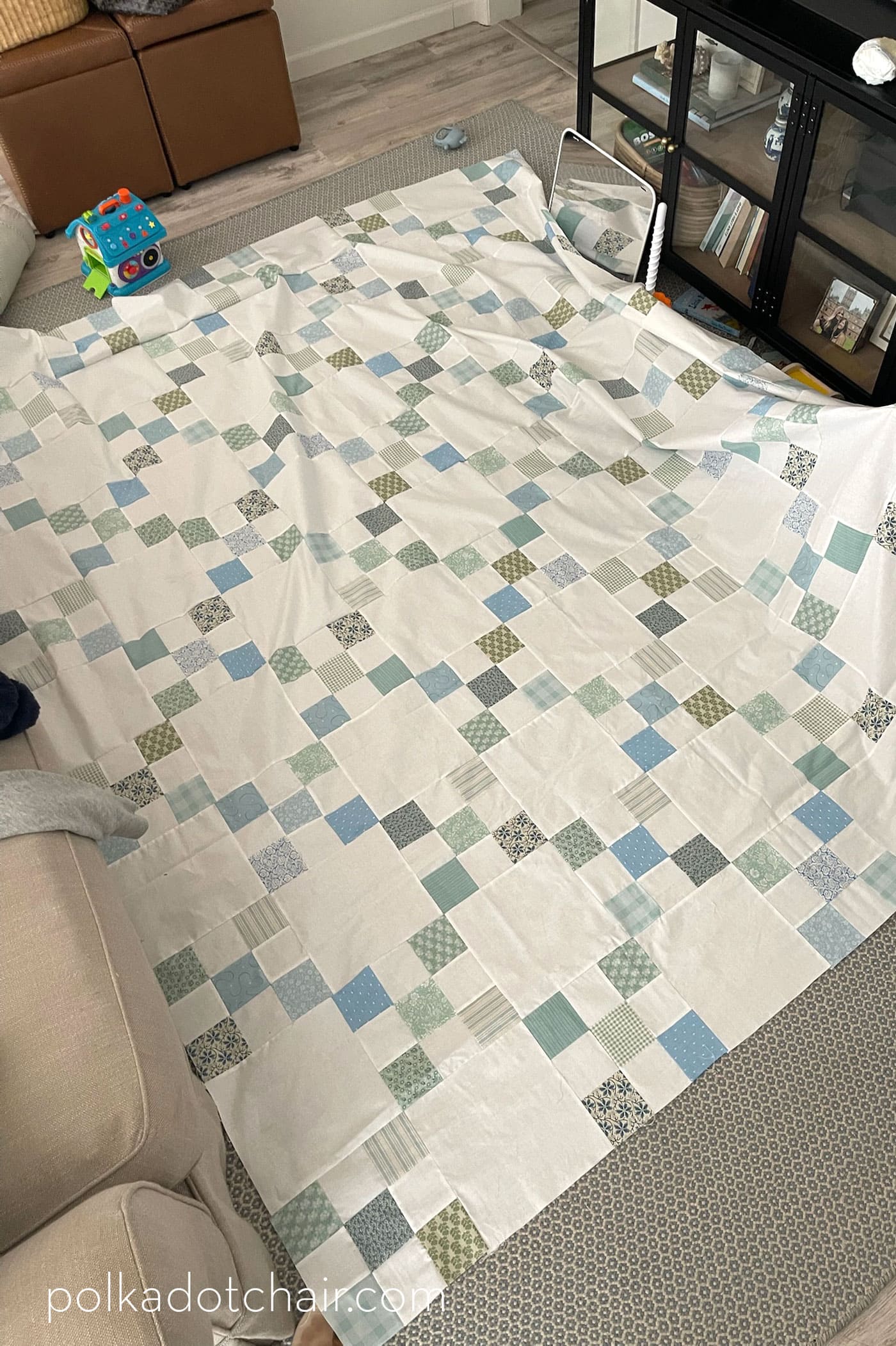blue and white nine patch quilt laid out on floor
