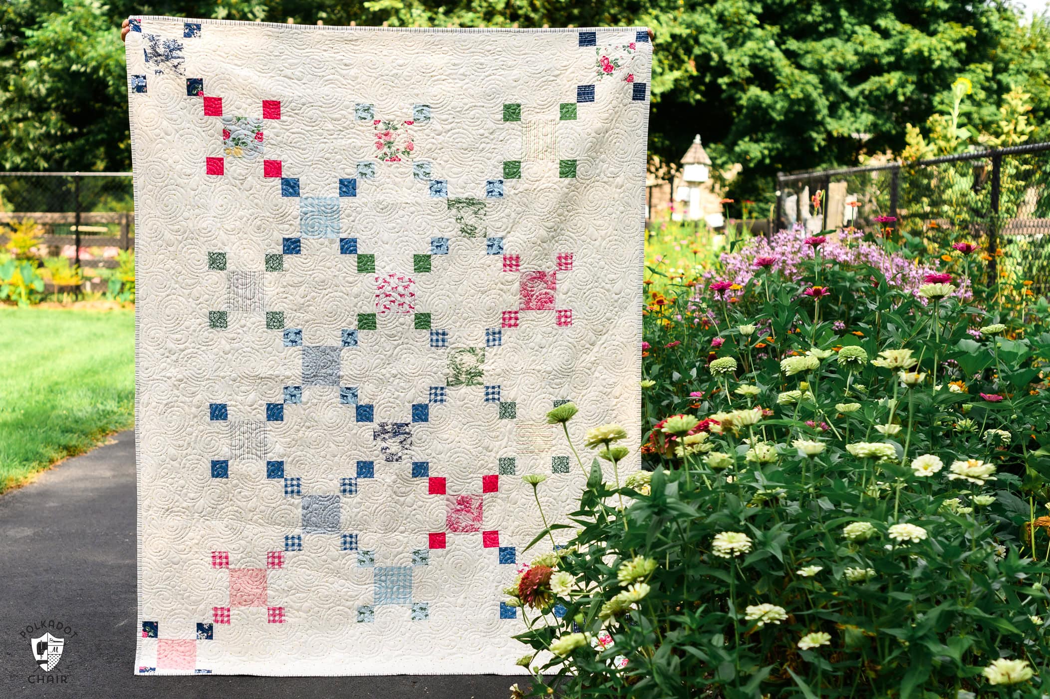 colorful chain quilt outdoors with flowers and greenery