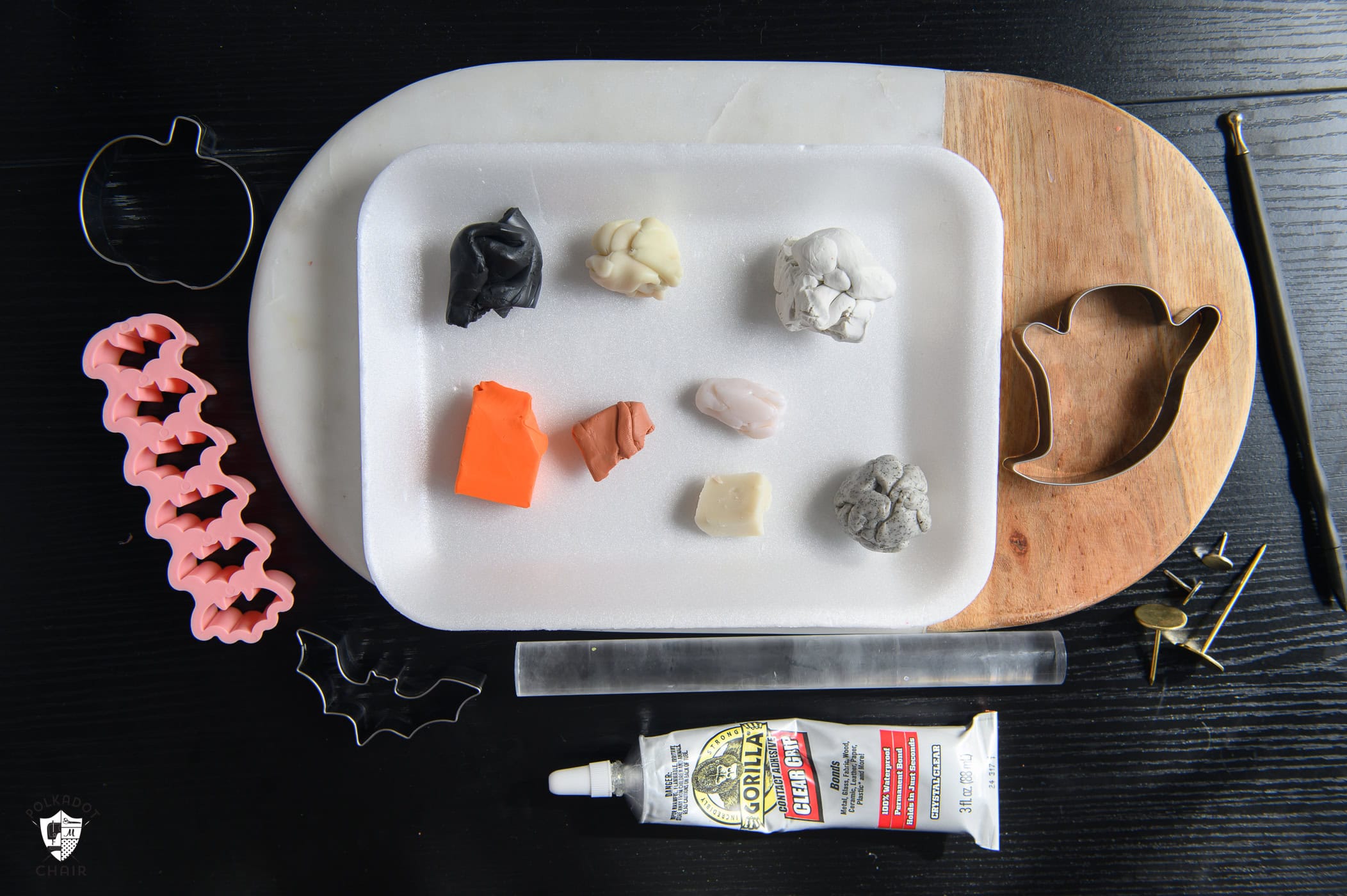 supplies for clay pins on black table