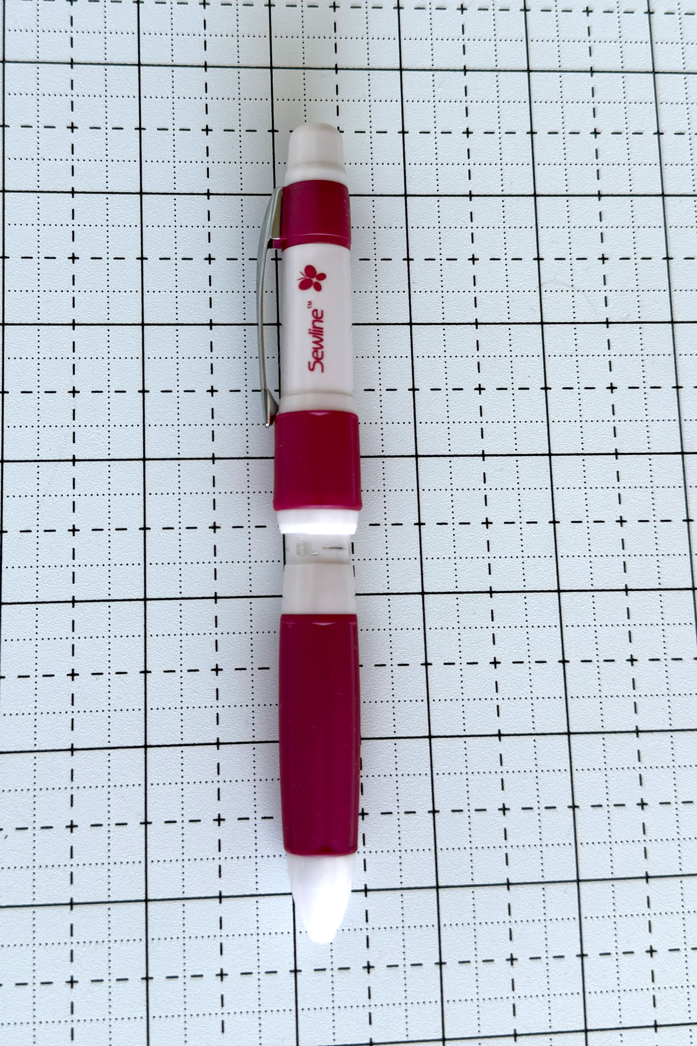 sewline pencil on white cutting mat