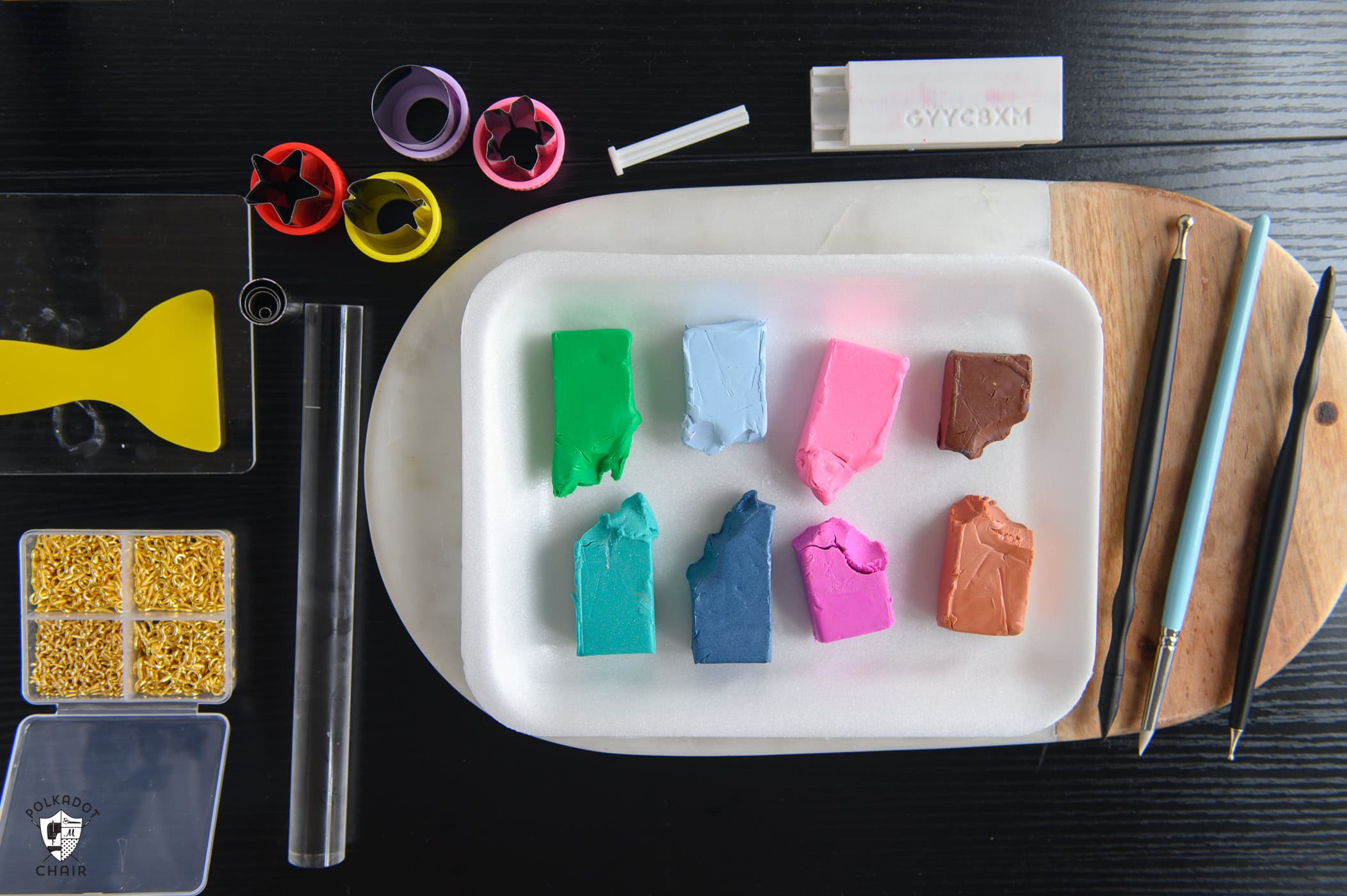 materials laid out, various colors of polymer clay and several polymer clay tools.