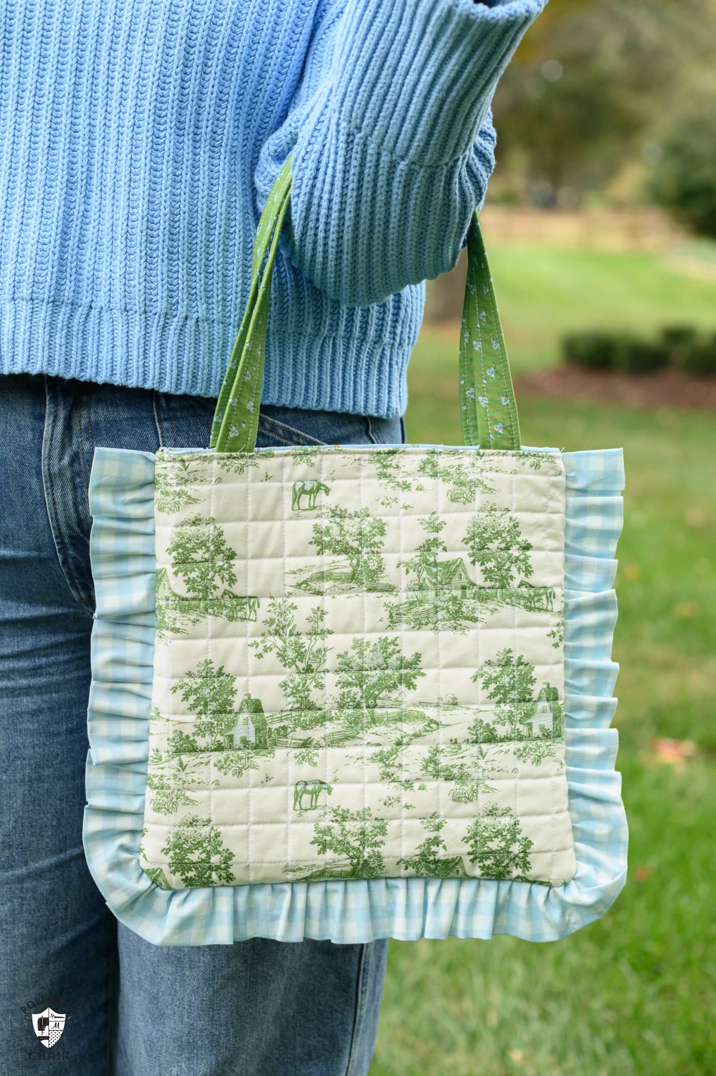 girl holding green and white quilted tote bag