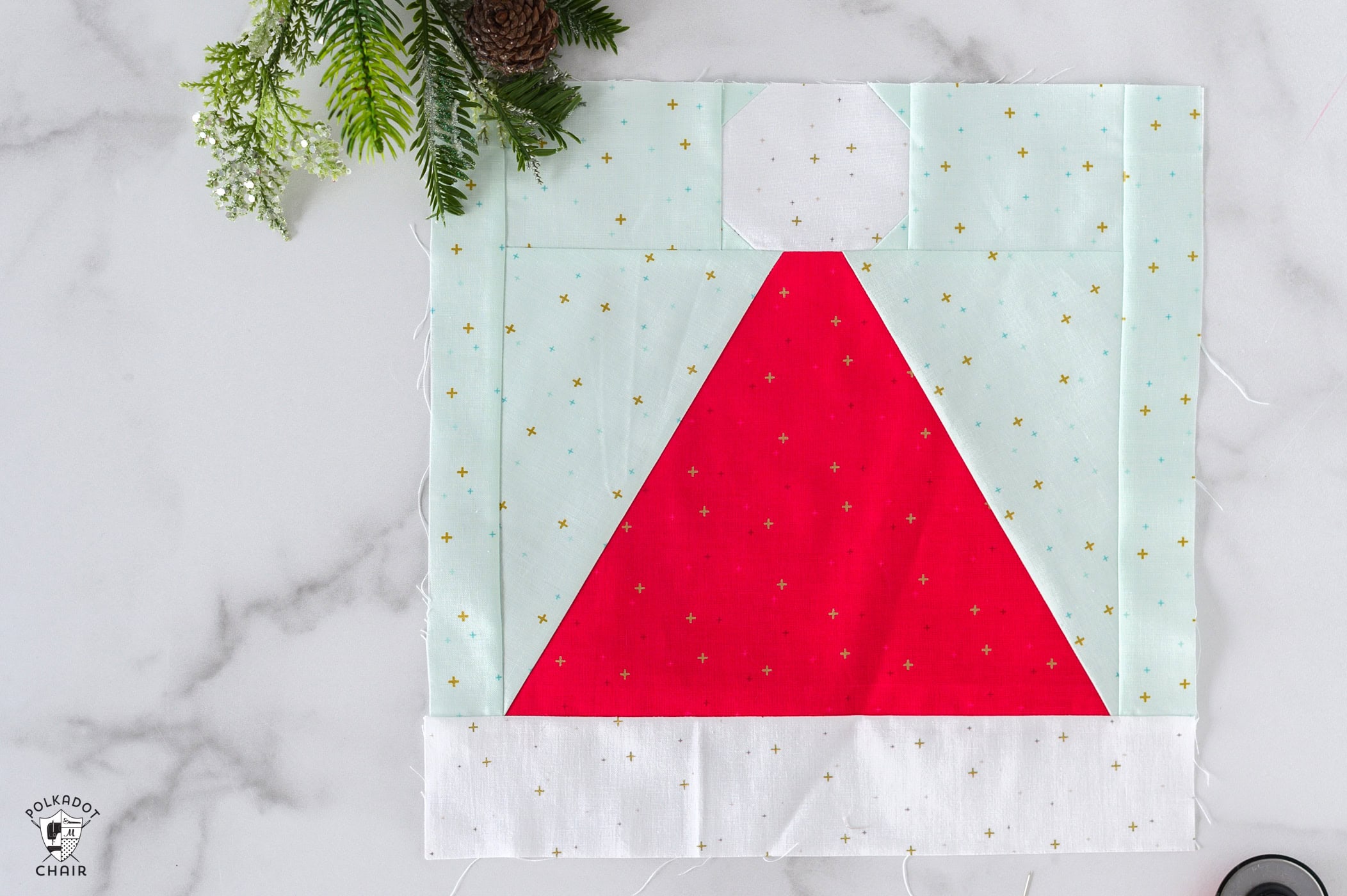 Santa hat quilt block on white table