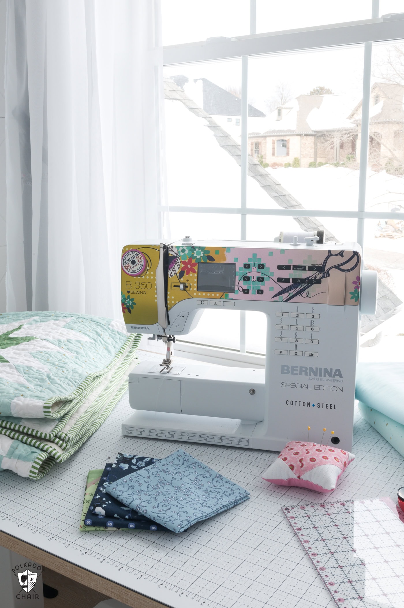 Sewing machine and notions on table by window in winter