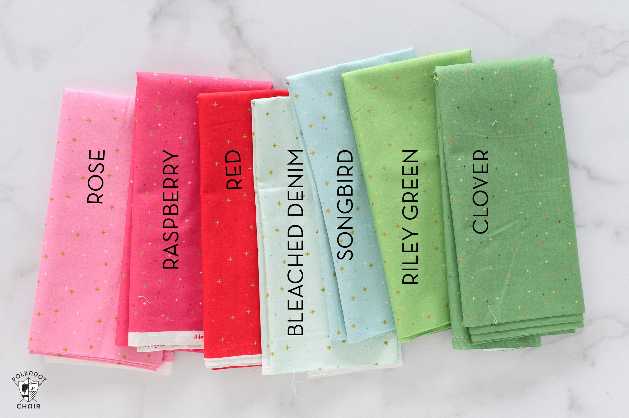 colorful stack of fabric on white table with text overlay