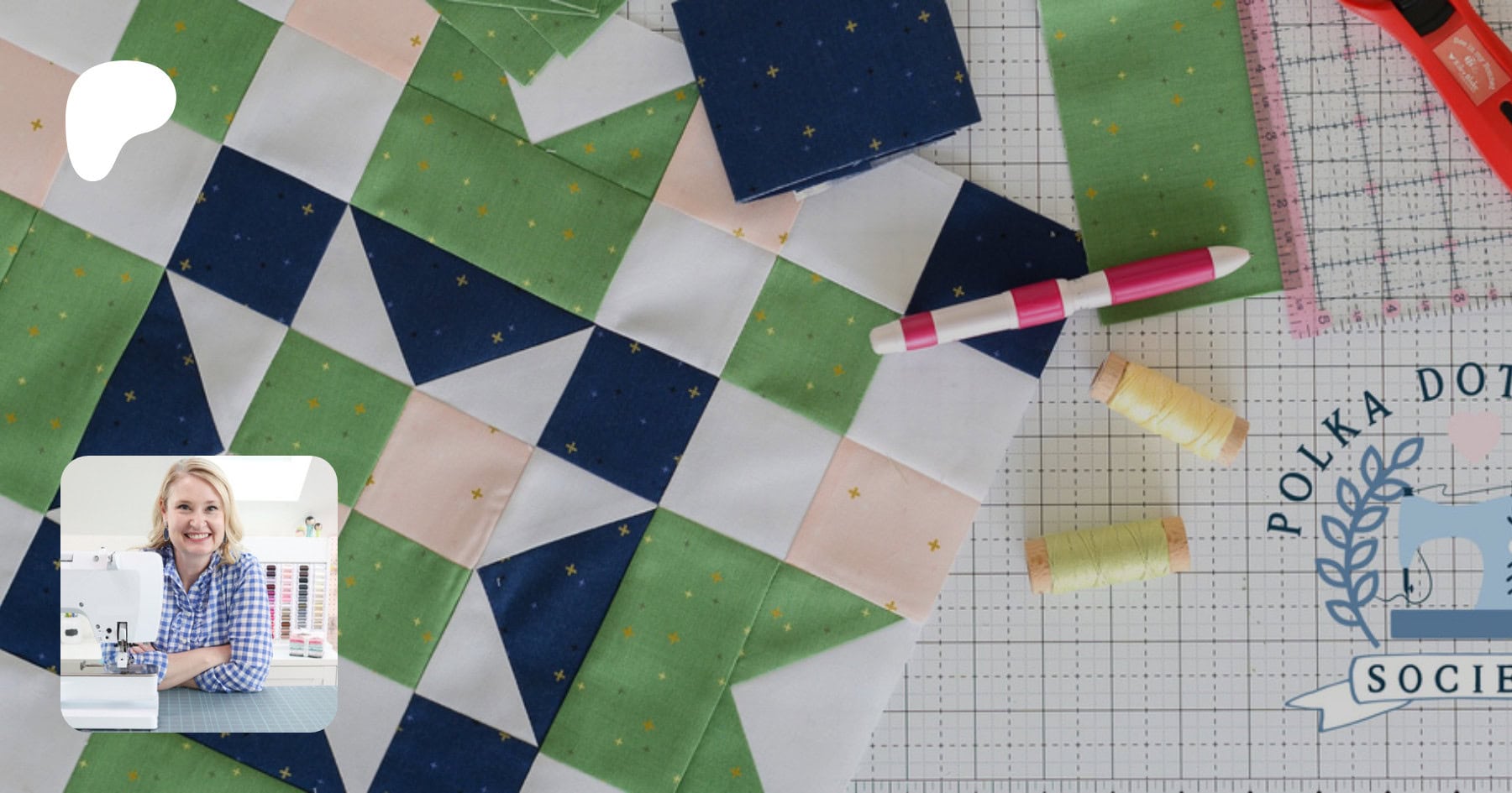 Green, navy, pink and white quilt block and fabric and quilt notions on white cutting mat with Patreon overlay