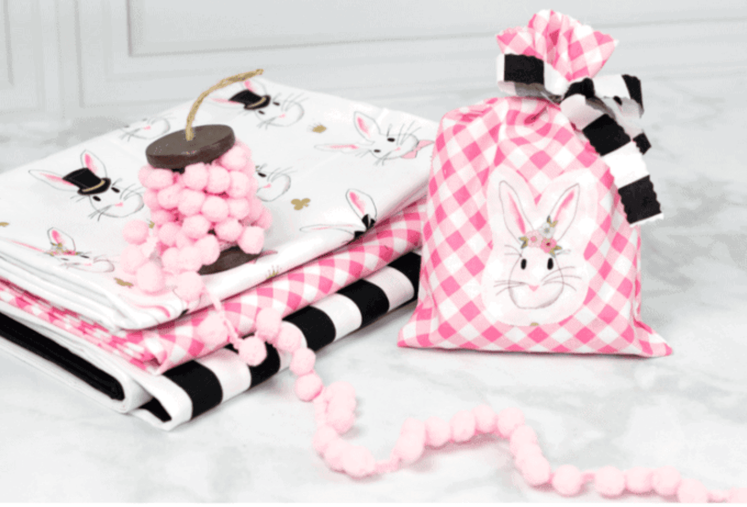 simple gift bag and stack of fabric on white table