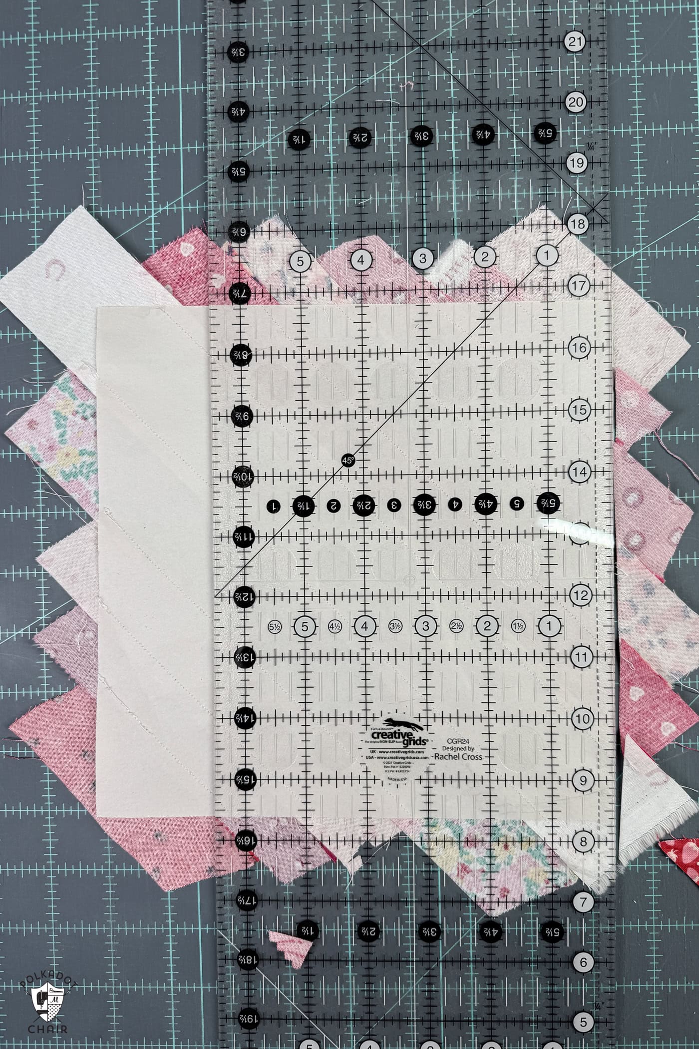 quilt ruler and paper and fabric on blue cutting mat