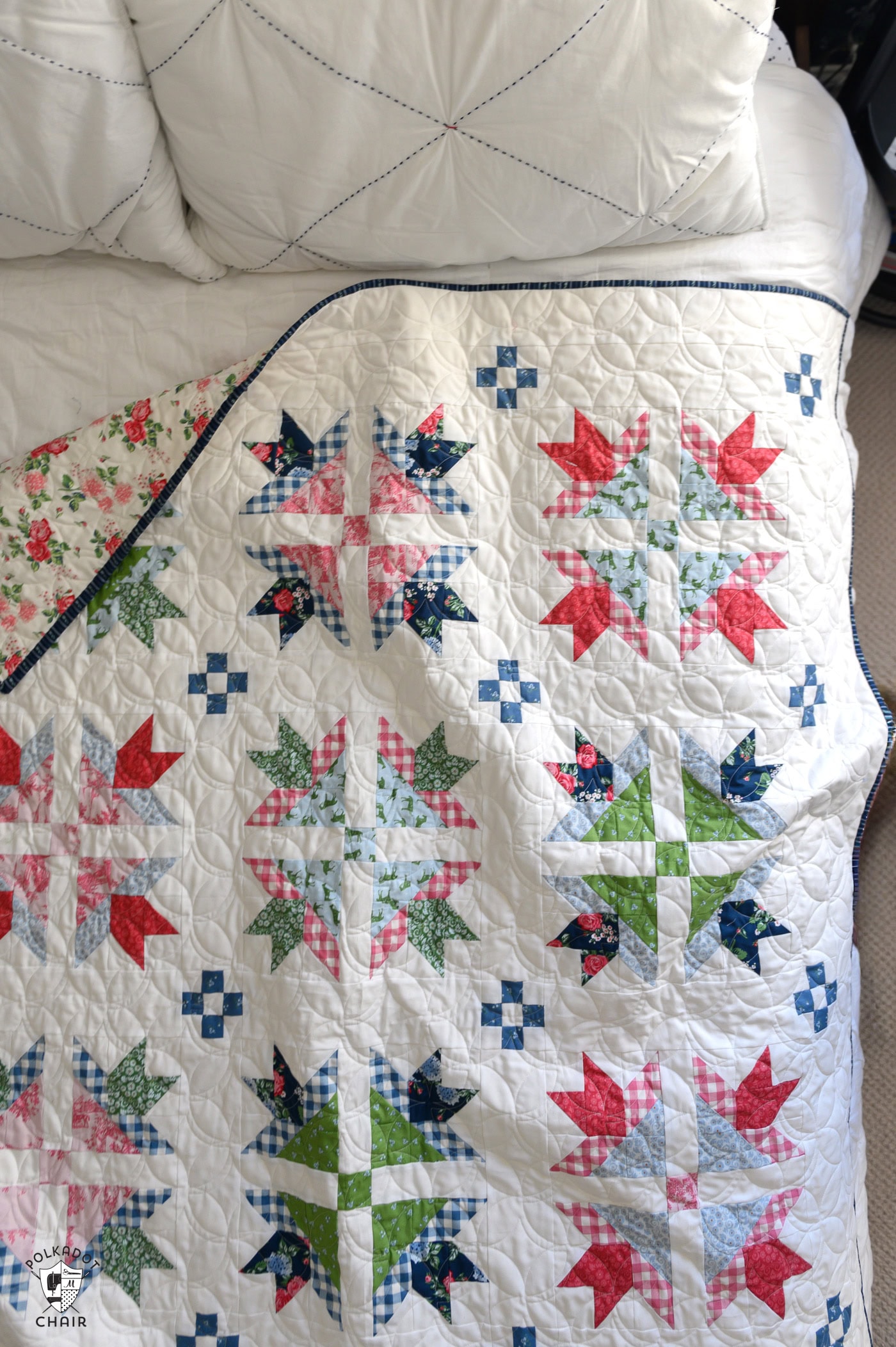 traditional red, green, pink and blue quilt on bed