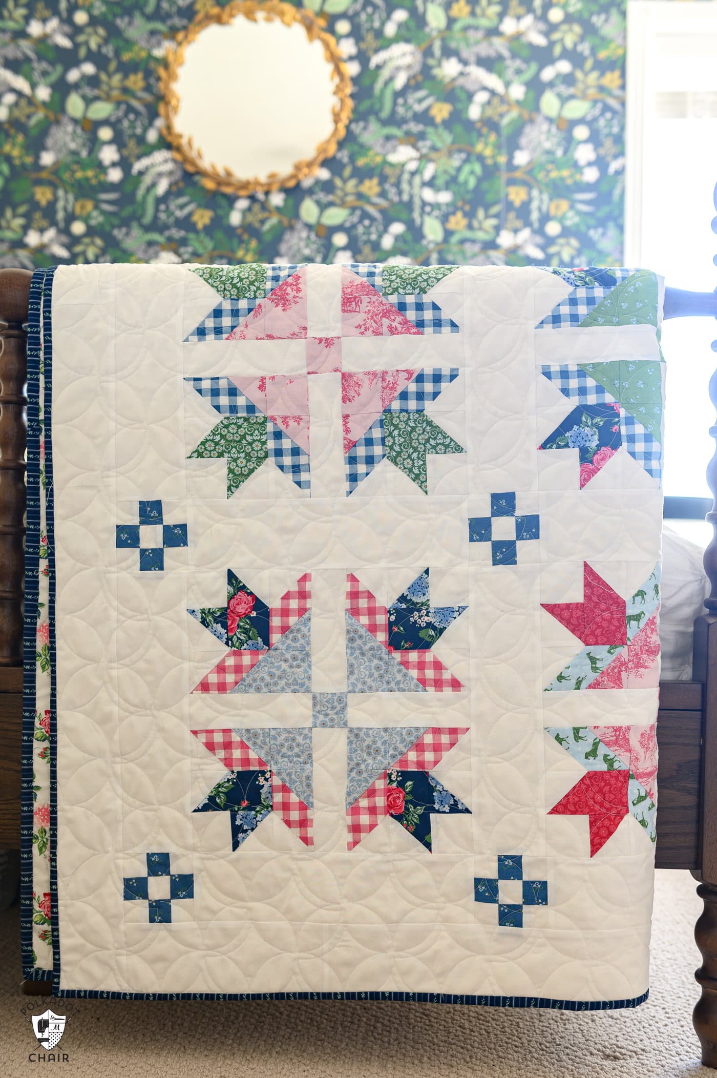 traditional red, green, pink and blue quilt on bedpost