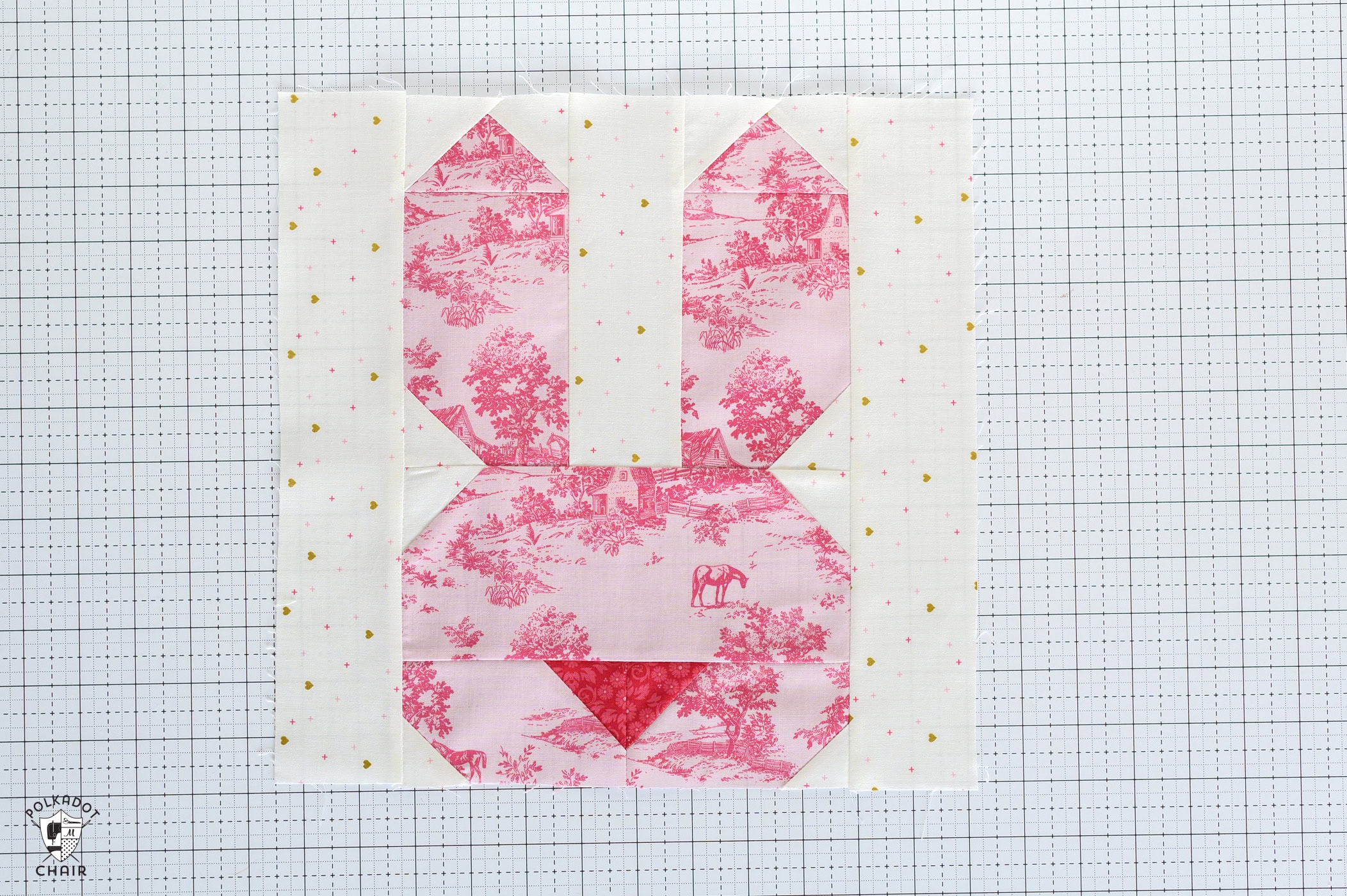pink bunny quilt block on white cutting mat