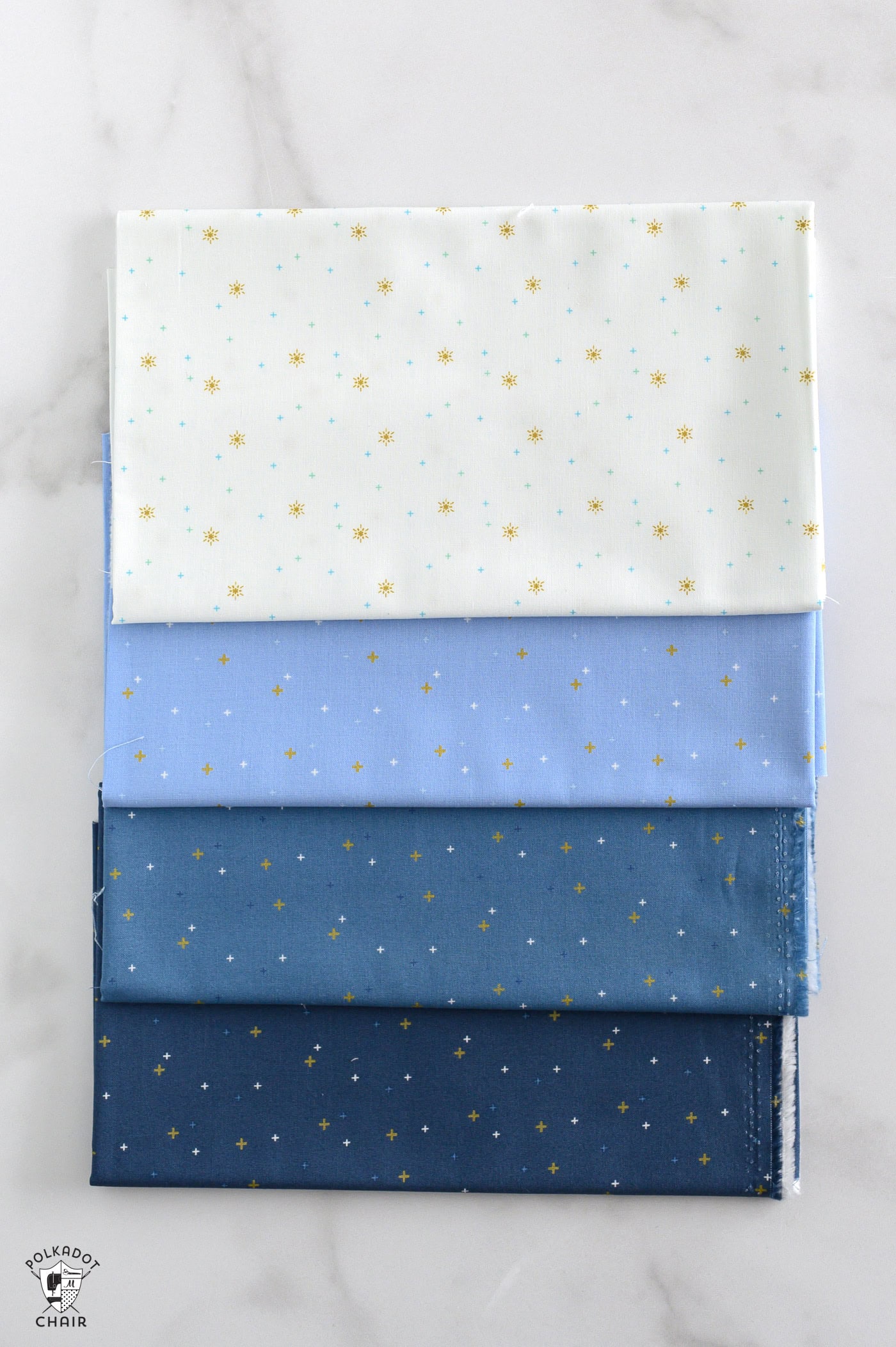 sparkler fabrics in bright colors folded on white marble table