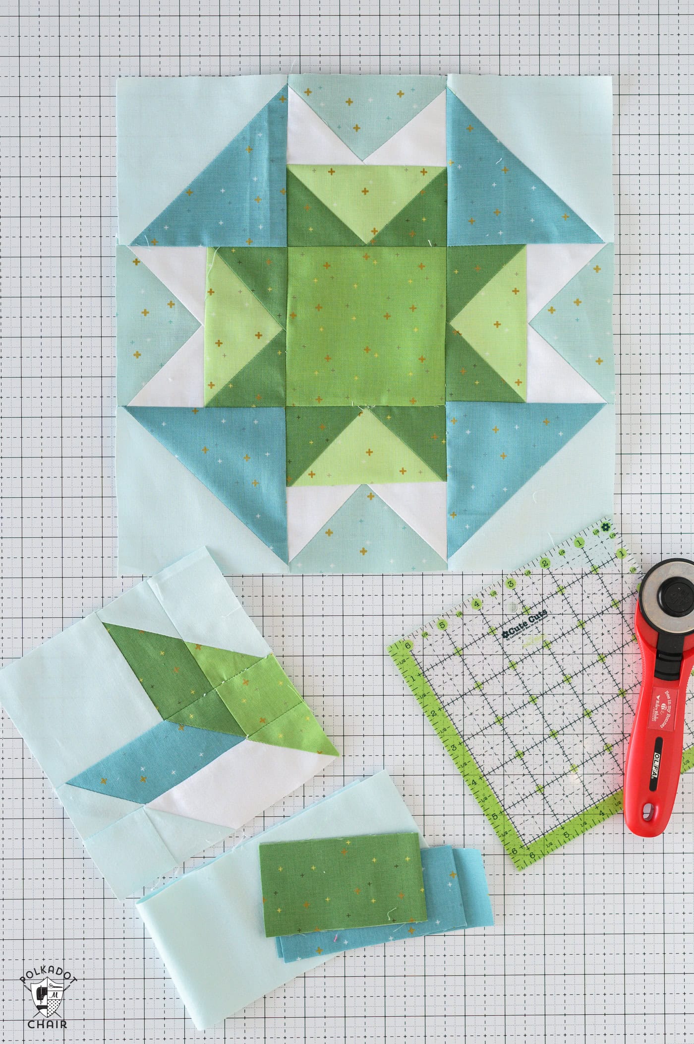 blue and green quilt blocks during the construction process on table