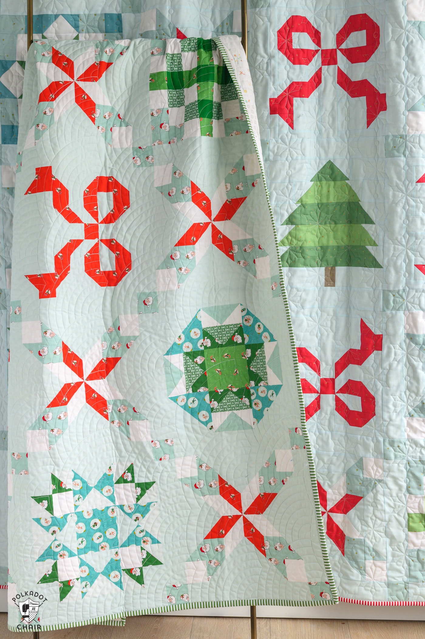 Colorful Christmas quilt with red, green, and white patterns and a zipper detail.