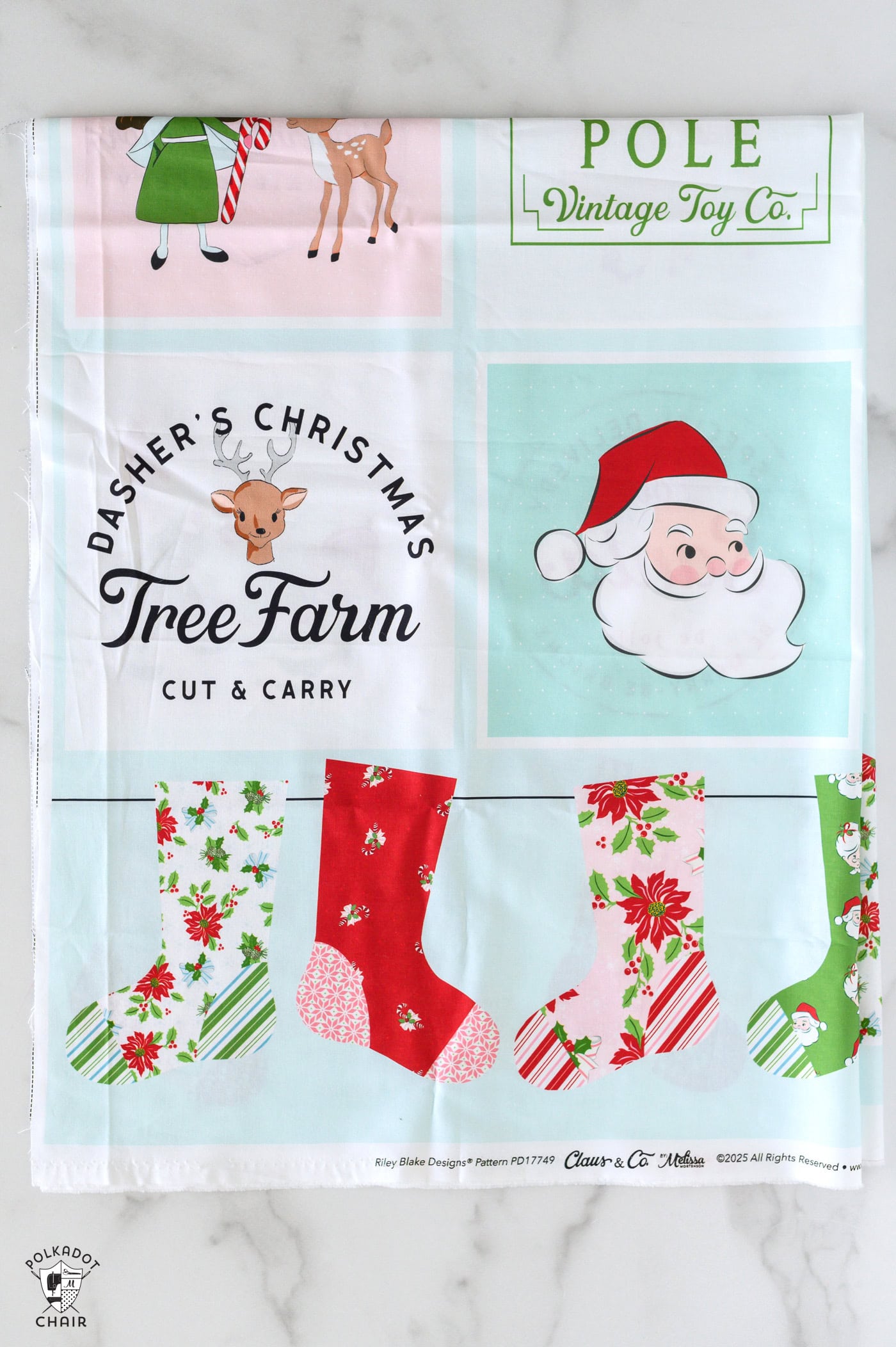 christmas quilt panel folded on white table