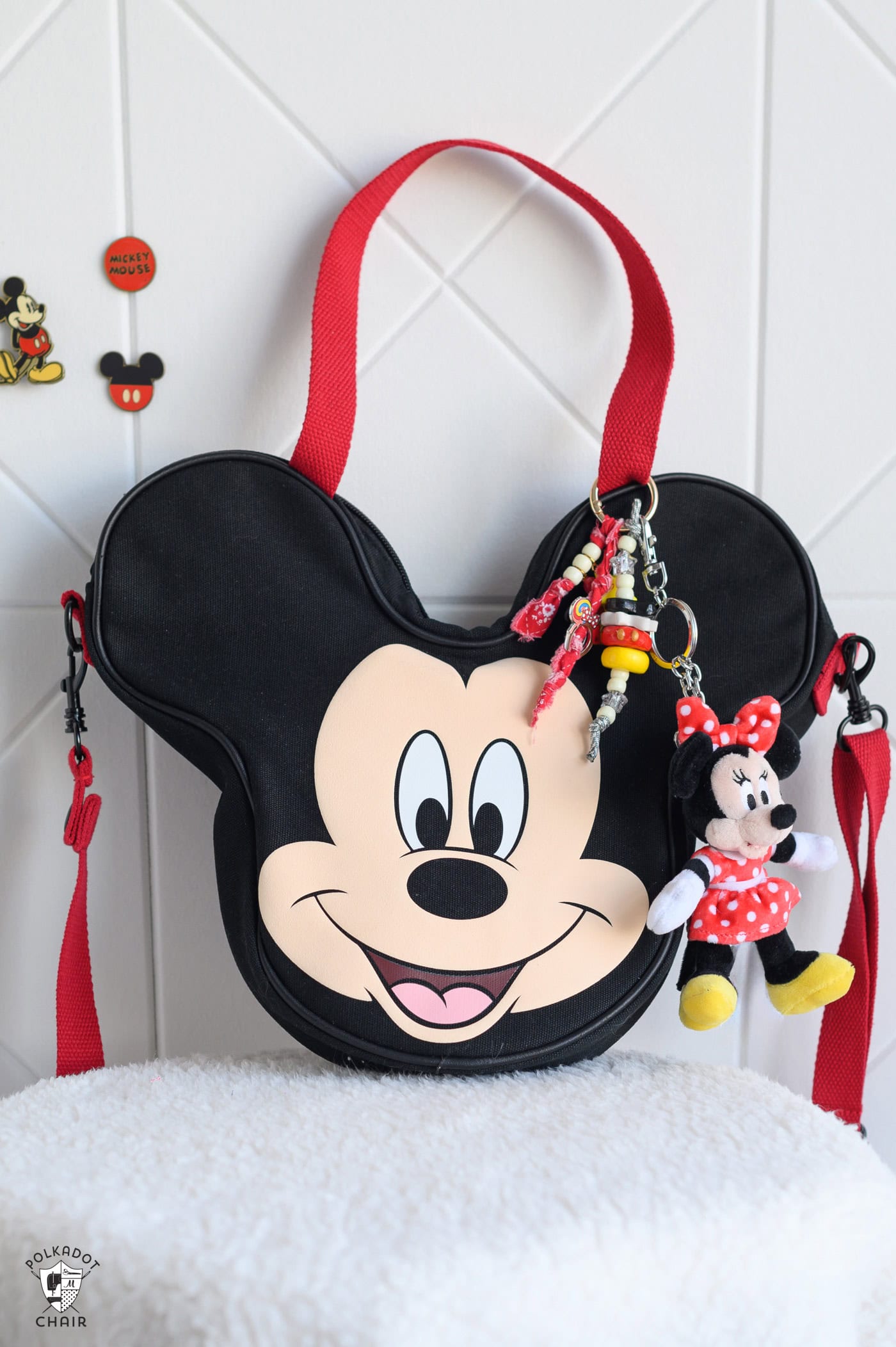 mickey shaped bag in front of white wall with disney charms