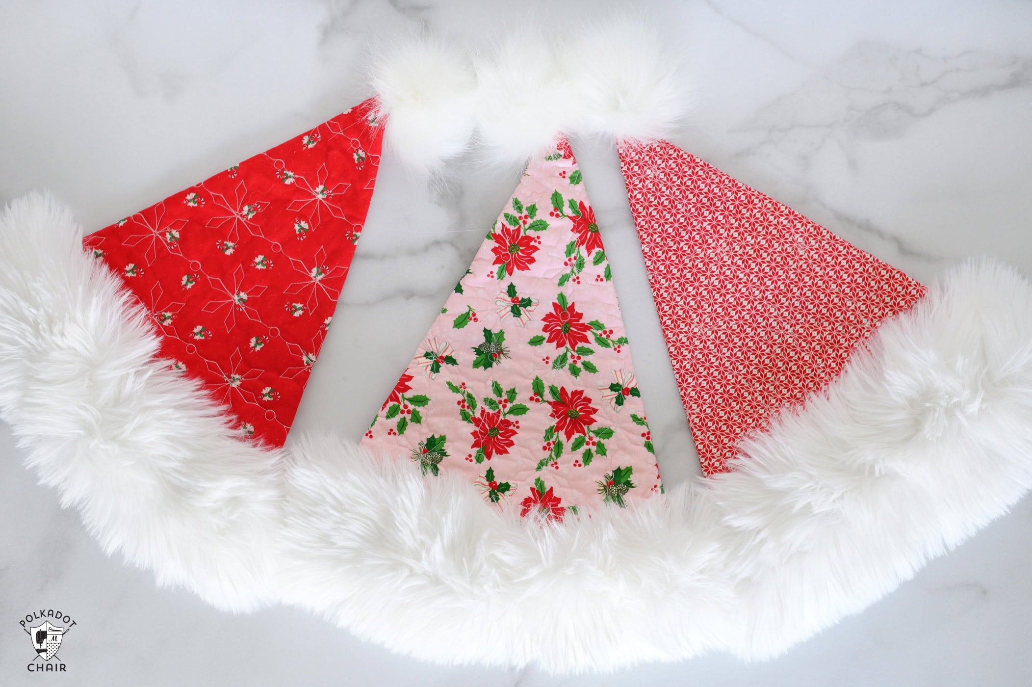 three santa hats on white table