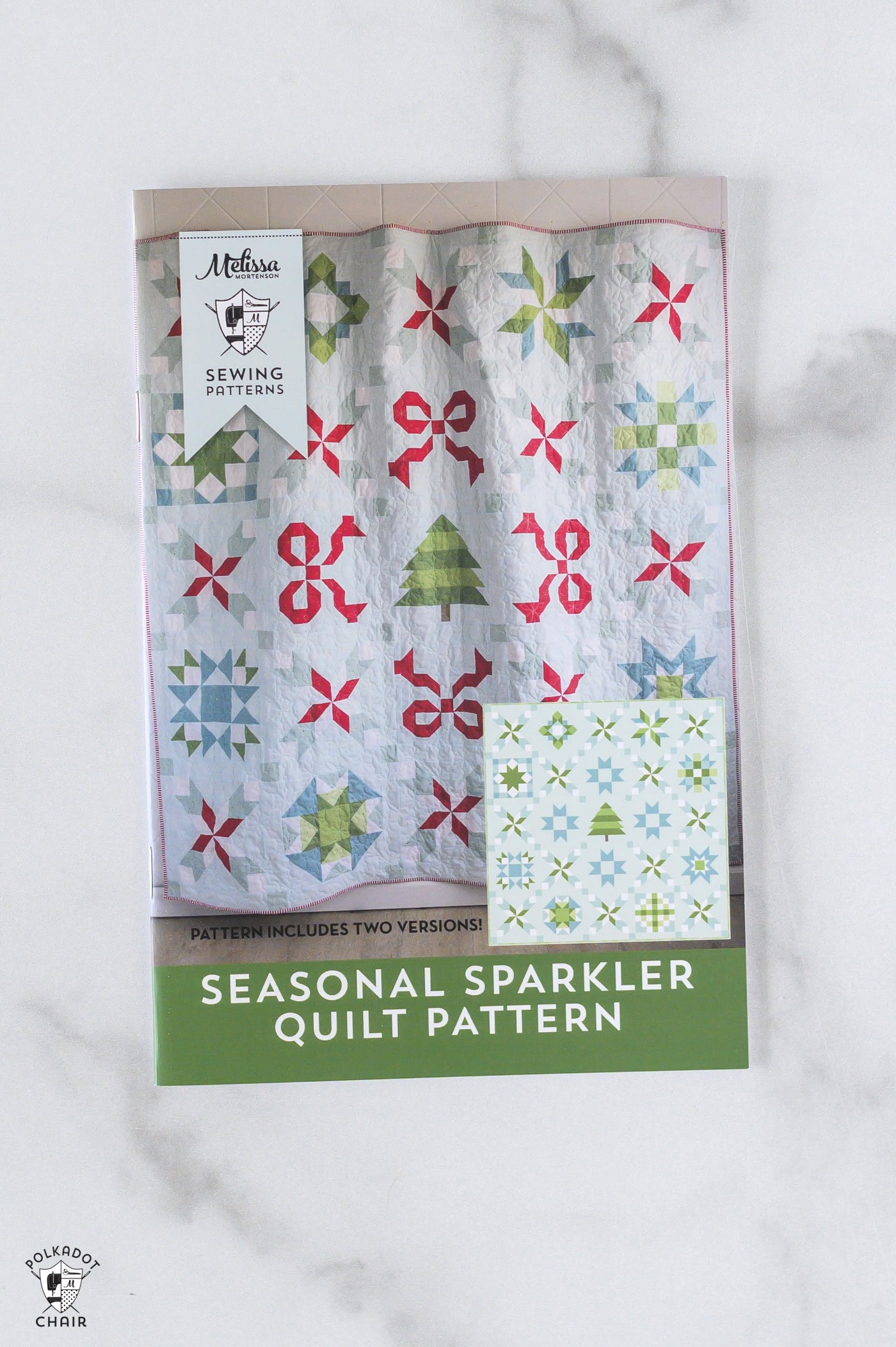 front cover of seasonal sparkler quilt pattern on marble table