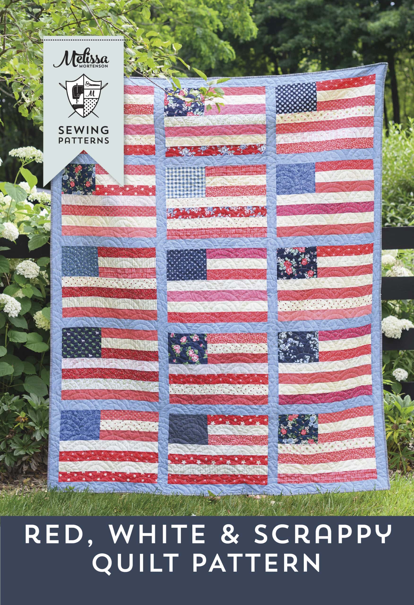 Patriotic quilt with red, white, and blue fabric scraps and American flag designs.