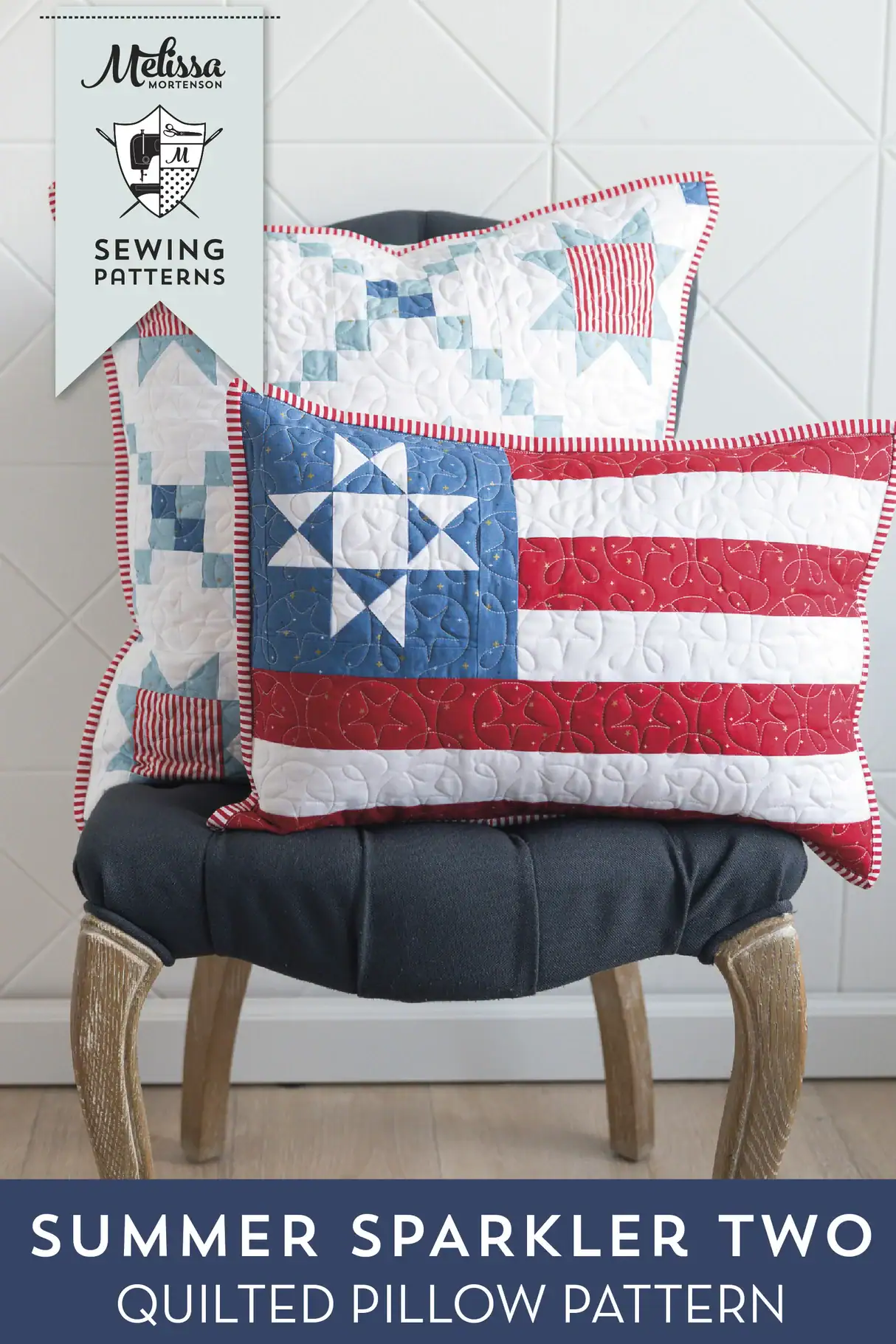 Two patriotic quilted pillows on chair in front of white wall