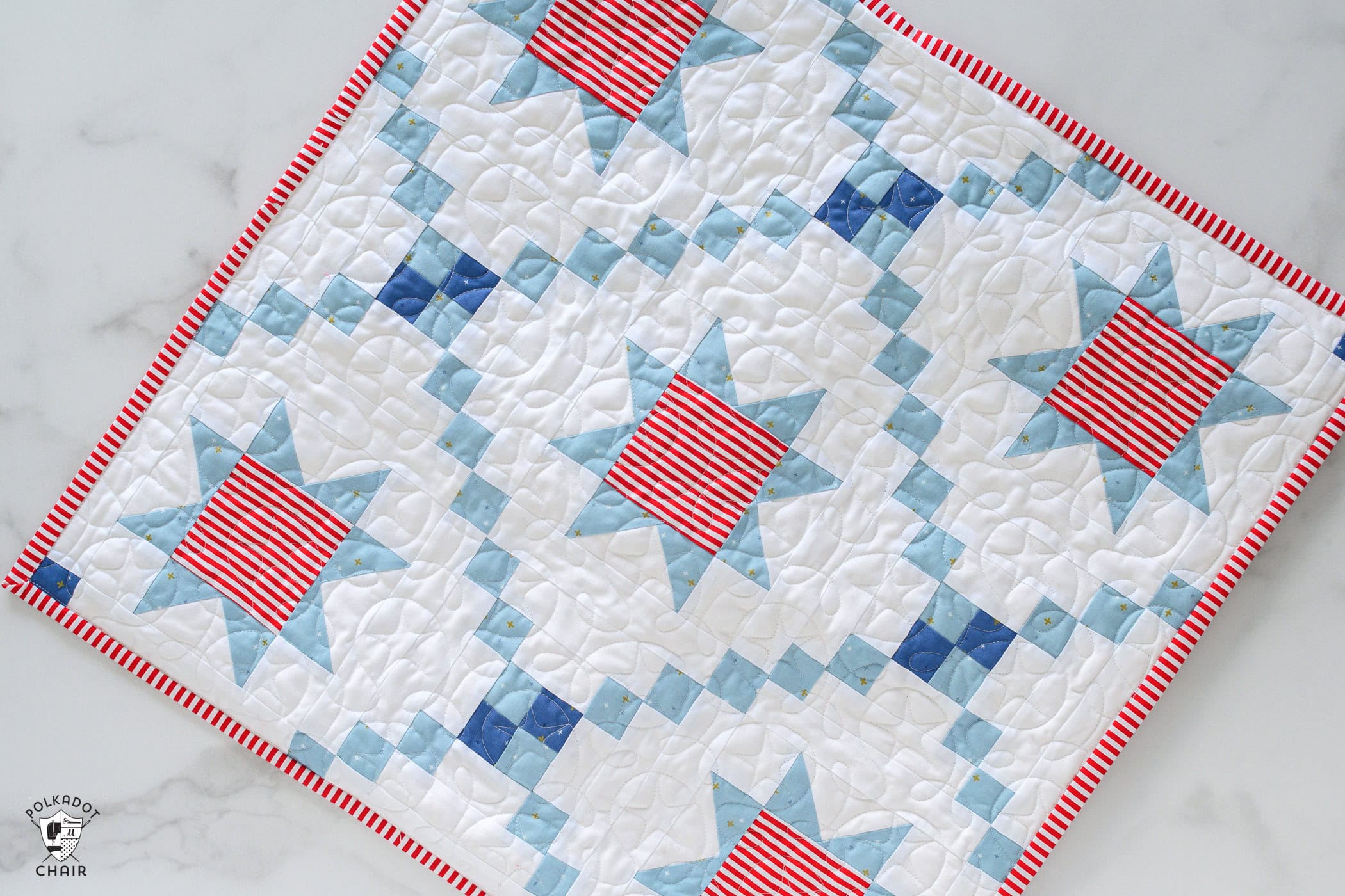 red white and blue quilted table topper on white table