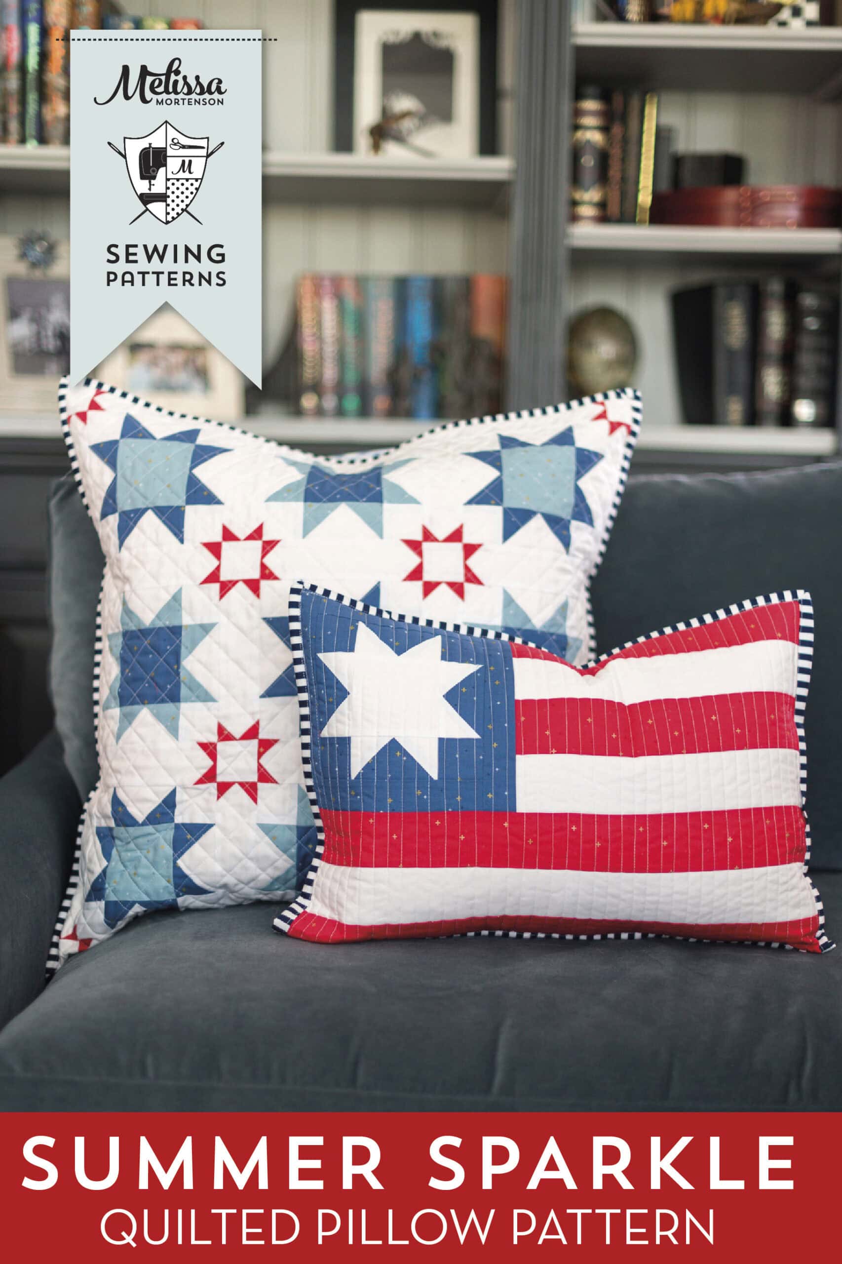 Two quilted patriotic pillows on sofa in front of bookcase