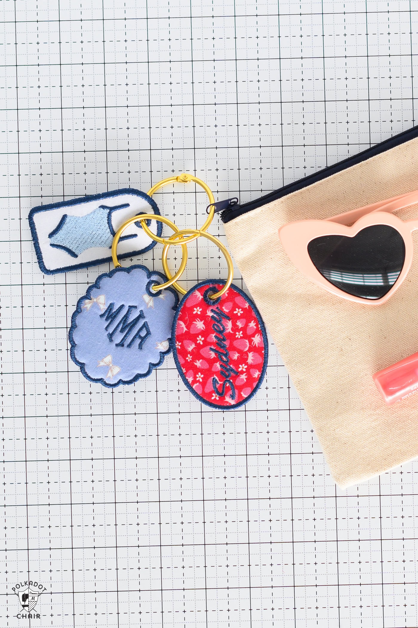 three embroidered tags on canvas pouch.