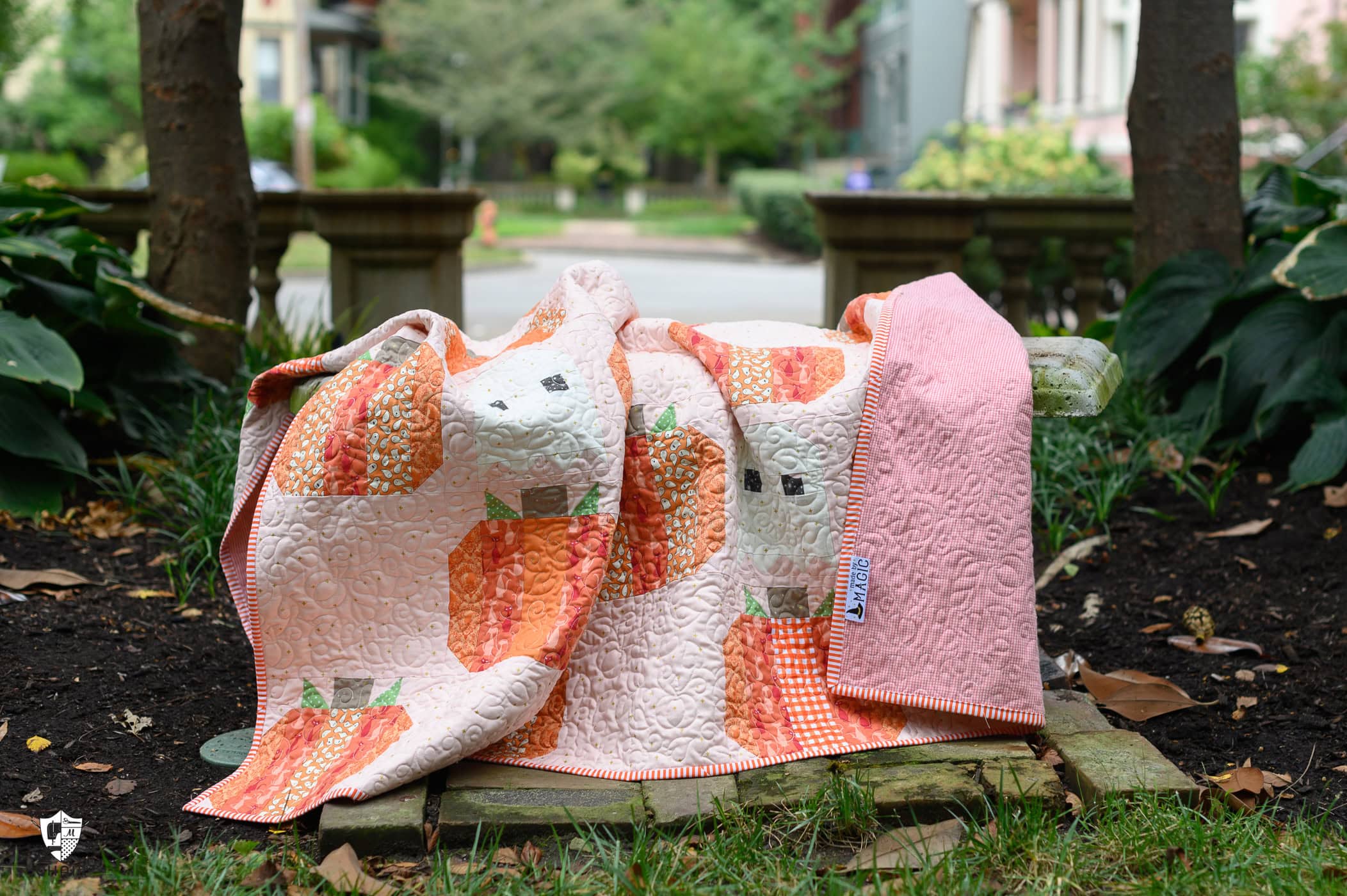 Colorful Halloween quilt outdoors on bench