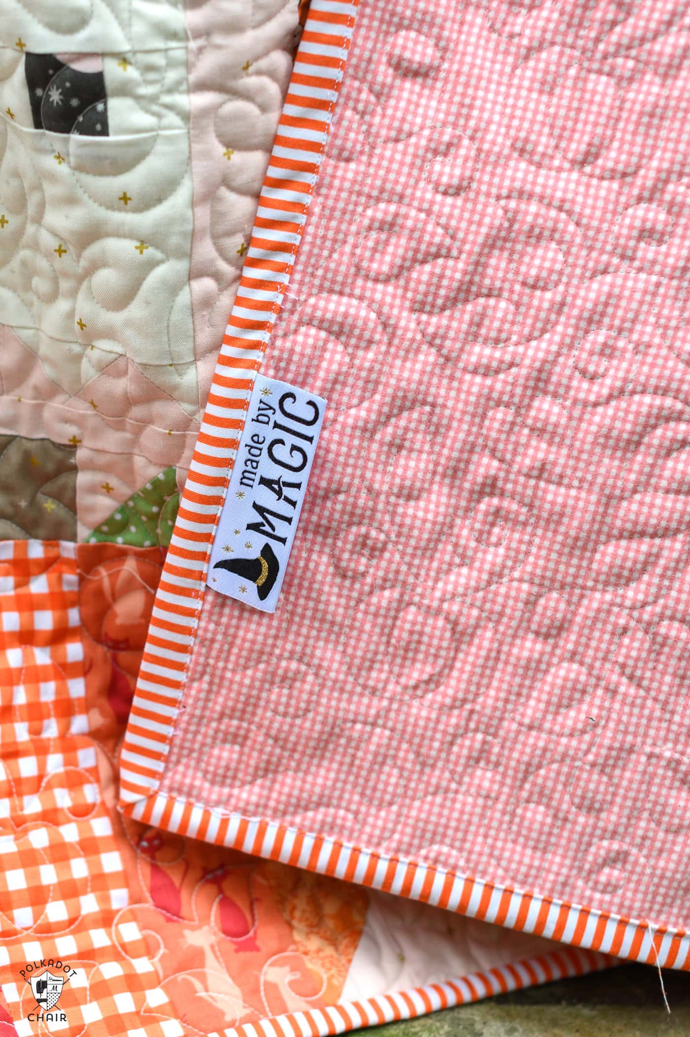 close up of made by magic woven label sewn into binding of quilt