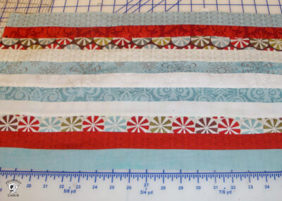 strips of sewn fabric cut on white cutting table