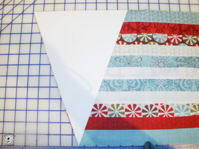 strips of sewn fabric cut on white cutting table