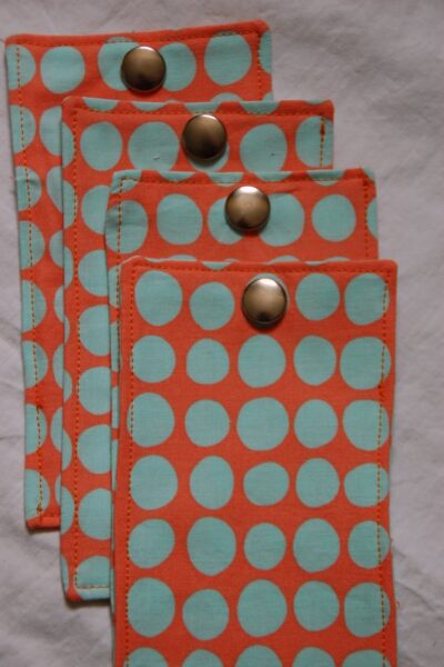 red, blue and coral fabric during construction process with sewing notions