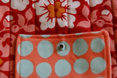 red, blue and coral fabric during construction process with sewing notions