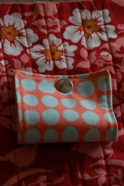 red, blue and coral fabric during construction process with sewing notions