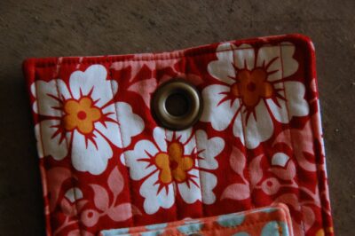 red, blue and coral fabric during construction process with sewing notions