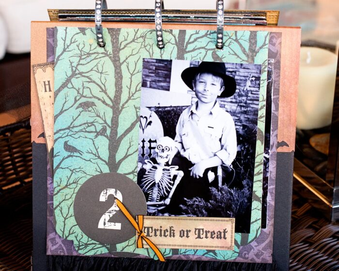 close up of page of collage scrapbook flip book- Halloween paper and stickers with black and white photos