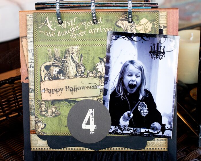 close up of page of collage scrapbook flip book- Halloween paper and stickers with black and white photos