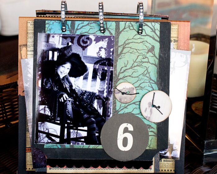 close up of page of collage scrapbook flip book- Halloween paper and stickers with black and white photos