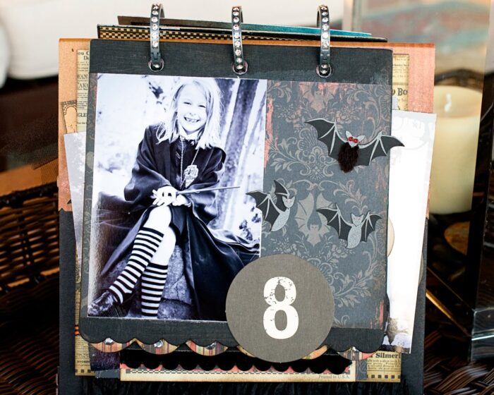 close up of page of collage scrapbook flip book- Halloween paper and stickers with black and white photos